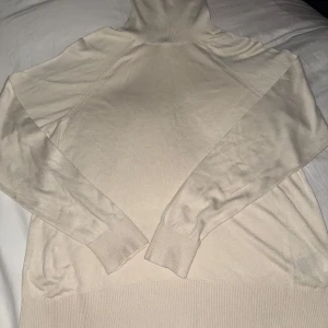 polotröja - En beige färgad polo tröja i maximal stretch. Använd 2-3 ggr. Tror från H&M  Storlek M men passar lätt mig som L Inga detekter eller nåt, mycket väl vårdad