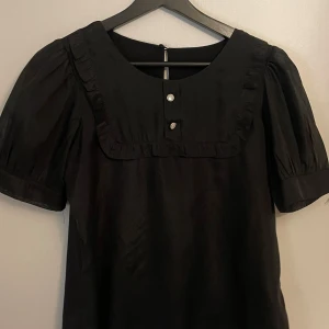 Svart kort puffärmad tröja - Helt ny, oanvänd svart blus, står ingen storlek i tröjan men skulle säga storlek S! Står inte heller vilket märke!