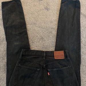 Svarta Levis 501 jeans - Säljer ett par klassiska svarta Levis 501 jeans. De har en rak passform och är tillverkade i slitstarkt denim. Perfekta för en stilren look, mycket bra skick!!!