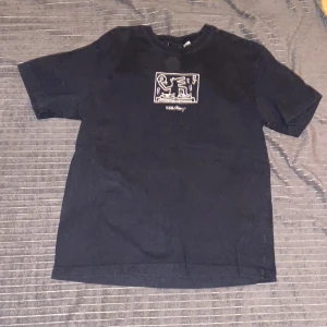 Svart t-shirt med konstnärligt tryck - Keith haring t-shirt, sprucket tryck. 