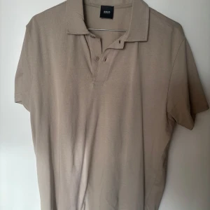 Beige pikétröja från Adverb - Snygg beige pikétröja från Adverb som är nätbutiken Jupiters egna märke. Endast använd 1-2 gånger. Är 191 lång och den är nog lite för kort för mig. 