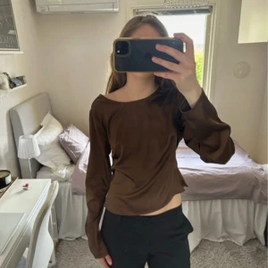 Öppen rygg topp - Topp med öppen rygg och band som går över ryggen. Satin material i brun färg. Från Nakd i storlek 36. Skriv om du har fler frågor!☺️