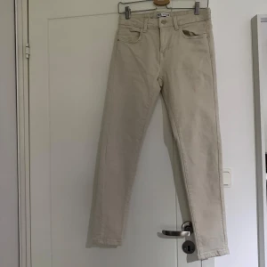 Beiga skinny jeans från Zara - Beiga skinny jeans från Zara med normalhög midja. Byxorna är i stretchiga