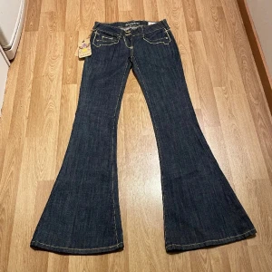 Lågmidjade bootcut jeans med specialfickor  - (35) lågmidjade bootcut jeans helt nya med lappar kvar, så unika detaljer och fickor. Midjemått rakt över: 35cm, innerbenslängd: 84cm🩵