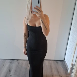 Svart långklänning  - Säljer en svart långklänning helt ny