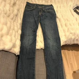 Levis 511 blå jeans - Klassiska blå Levis 511 jeans med raka ben och normal passform. Jeansen har fem fickor, synliga sömmar och stängs med knappgylf. Perfekta för en avslappnad stil och tillverkade i slitstarkt denimtyg. 29/30