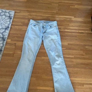 Ljusblå bootcut jeans från Zara - Säljer ett par ljusblå low waist jeans från Zara med bootcut-modell. Jeansen har klassisk femficksdesign, dragkedja och knapp framtill.