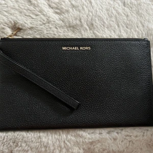 Michael Kors Clutch - Michael Kors clutch/väska med ett litet fack samt ”kort-fickor”. I nyskick! 
