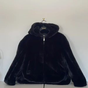 Vårjacka - Fin fluffig svart vårjacka från Zara i storlek Xs. Den har luva och lite längre i bak. Använd under en vår.