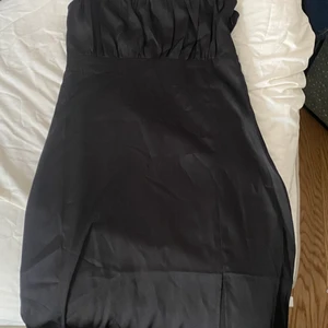 Svart klänning - Säljer denna svarta långa klänning. Köpt från HM i storlek 36 och har endast använt den en gång. Klänning har en fina detaljer vid bröstet och en slitt vid benet. Nypris ca 300kr. Jag säljer för 200kr då den knappt är använd. Köparen står för frakt eller så kan vi mötas upp💓