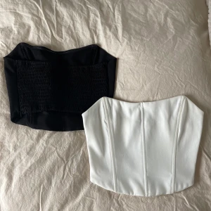Korsett toppar - Säljer dessa superfina korsettoppar från nakd. Den vita är använd en gång och den svarta tre så jättebra skick inga defekter. Stängs med dragkedja.  Frakt tillkommer. Många intresserad så lägg gärna bud. Svarta såld!!