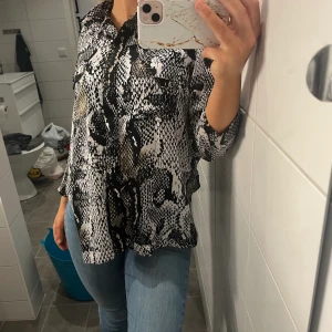 Ormmönstrad blus - Strl 36, hyfsat ny blus, aldrig använ, kortarmad. Man står för frakt själv. 