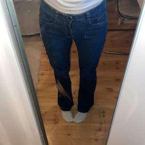 Snygga mörkblåa straight jeans med coolt mönster på bakfickorna