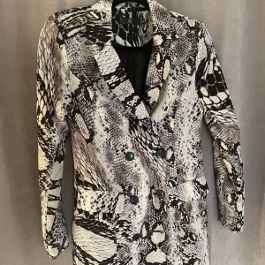 Blazer-klänning - Blazer-klänning med knappar fram. Kortare modell - slutar över knäna.