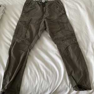Forest Green Cargo Pants - Nice Cargo pants in perfect condition. Many pockets with buttons on every pocket to close.