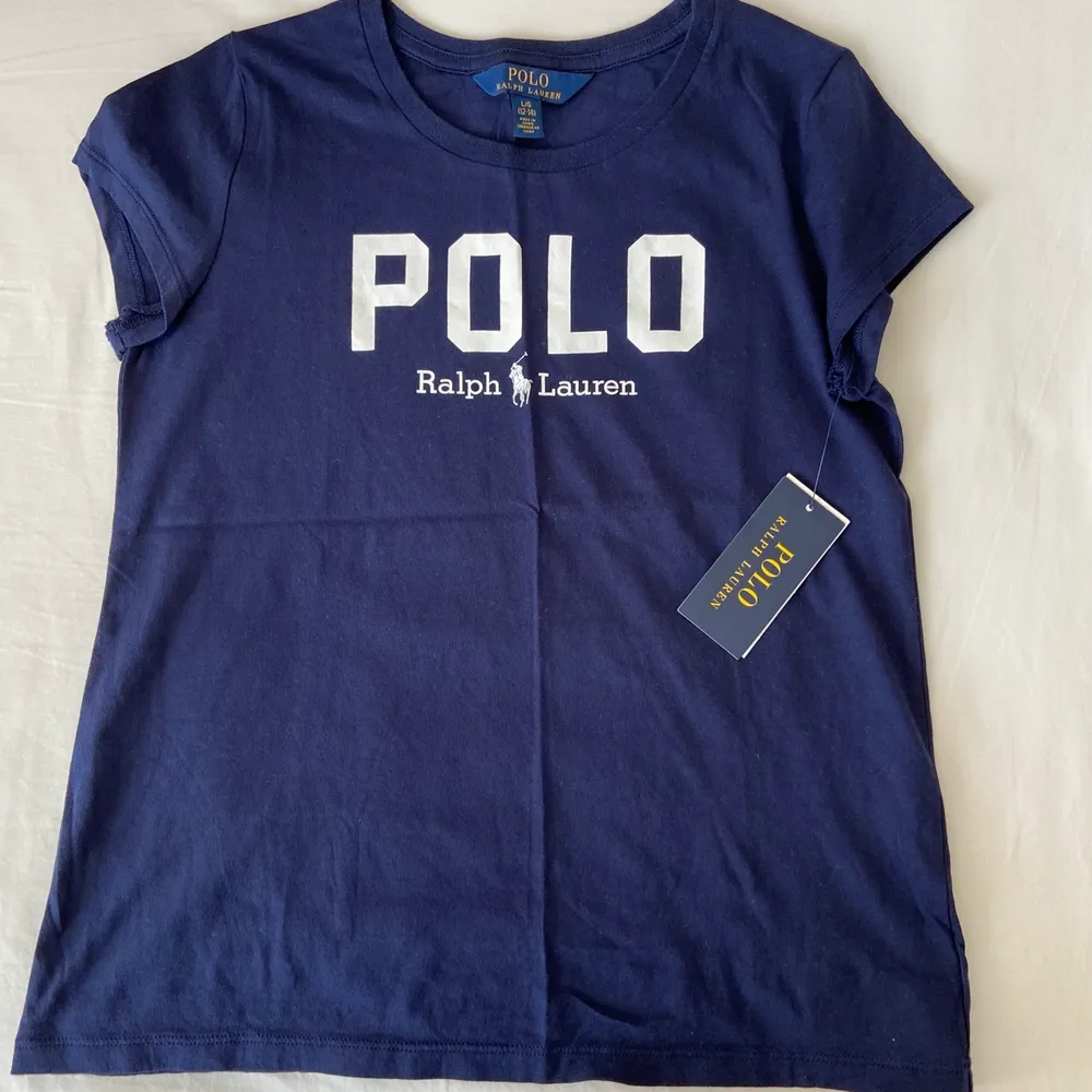 Helt oanvänd polo t-shirt med lappen kvar från Ralph Lauren. Köpt för 425kr och är i stl. L (barn) vilket motsvarar XS-S.. T-shirts.