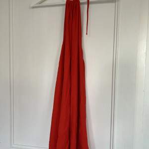 Säljer denna röda klänning med öppen rygg. Klänningen är bara använd ett fåtal gånger och i bra skick. Perfekt inför sommaren!