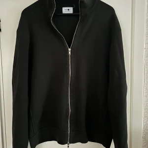 NN07 mörkgrön Zip tröja utan luva  - NN07 mörkgrön Zip tröja utan luva. Står att storleken är XXL men passar mig som har storlek L i alla mina kläder. Den passar L och Xl. Inga fel eller skador på tröjan (Nyskick).  Nypris: ~2000kr Säljer för 799kr