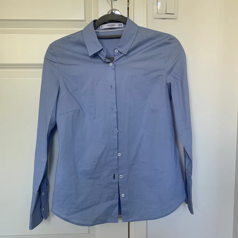 En blå skjorta från mango i srl Xs. Använd ett fåtal gånger och är i nyskick. Passar det mesta och är sann till storleken. Frakt tillkommer!. Skjortor.