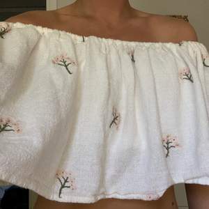 Säljer en vit offshoulder topp med blommor från Zara. Nästan helt oanvänd i storlek L men passar mig som brukar ha storlek S. 