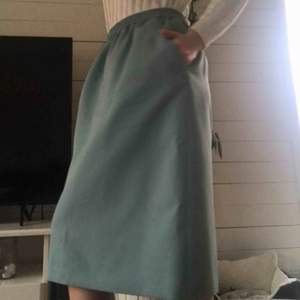 Fin och unik turkos kjol i tjockt material med fickor (!!!!). Tror den är handgjord av privatperson, därav ingen exakt storlek eller märke. Köpte den oanvänd secondhand. Använd 1 gång. Slutar strax under knät på mig som är 170 cm. Frakt tillkommer🧸