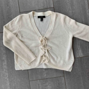  - Stickad tröja med snörning fram, ganska liten i storlek. Använd max 5 gånger. frakt tillkommer 