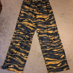 Tiger print wide pants  - Vida byxor i tiger print fr & Other Stories. Har två defekter som syns på bilden. Skickar gladeligen fler bilder om så önskas. Meetup i sthlm eller fraktas, som köparen står för. 