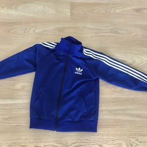 Adidas jacka storlek m - Blå adidas jacka i storlek M. Kan mötas upp i Stockholm eller så står köparen för frakten