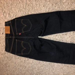 Mörk blåa Levis jeans  - Mörk blåa jeans från Levis i storlek 25, motsvarar ungefär en XS-S skulle jag säga. Original pris 1000 kr. Aldrig använda endast testade.