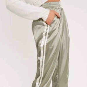  - Lätra byxor med vita ränder i luftigt material silkesgrön färg. Höga i midjan! Snygga till allt! Aldrig använda