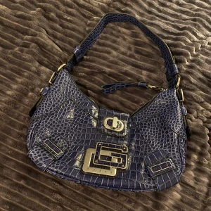 Skinn väska (shoulder bag) - Säljer en skinn väska (shoulder bag) från Guess. Gammal model men helt äkta | är lite större än jämfört med bilden!!och passar även på allt💜Buda med minnst 20kr<3 (köp direkt för 400kr🥰)