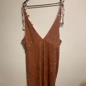 Bought new, never been worn, perfect condition, soft velvet with adjustable straps and low cut front and back, very stretchy and comfortable. 