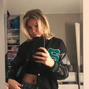 Collegejacka  - Säljer min svarta collegejacka med gröna detaljer. Är i nyskick! Många intresserade så lägg ett bud! Bud just nu: 300 + frakt💕