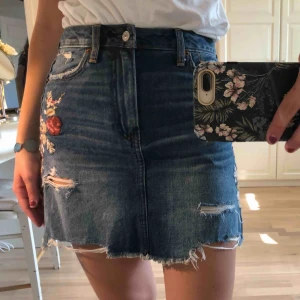  - Supersnygg jeanskjol från Abercrombie & Fitch, fina blom-detaljer på sidorna. Frakt: 60kr 