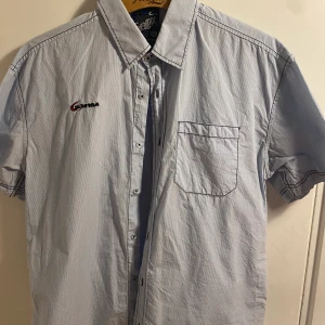 Hawaii skjorta med backprint  - Fet kortärmad hawaiiskjorta med print på ryggen. Storleken är xxl men den sitter som en M eller mindre. Den är inte använd och saknar flaws. Unisex. Påminner om nått som man kan cruisa runt med i Los Santos