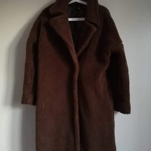 Teddyjacka från Nelly - Lång brun teddyjacka, passar till höst och vinter, storlek 34. Endast använd ett fåtal gånger, knäpps med 1 knapp 😍 nypris 800 kr. Köparen står för frakten! 