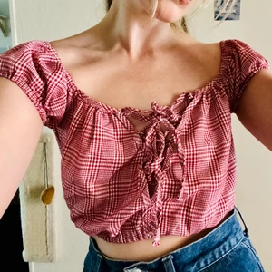 Rutig bardottopp - Går att ha på lite olika sätt, stretch i öppningar och snörning fram. En ganska liten small dock. Sparsamt använd, inga defekter!