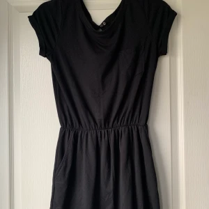 Playsuit  - En söt playsuit i svart! Basic med en ficka framtill vid bröstet. Reså i midjan som gör att den sitter fint. 