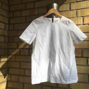  - krispig blus från COS med svart spänne i ryggen