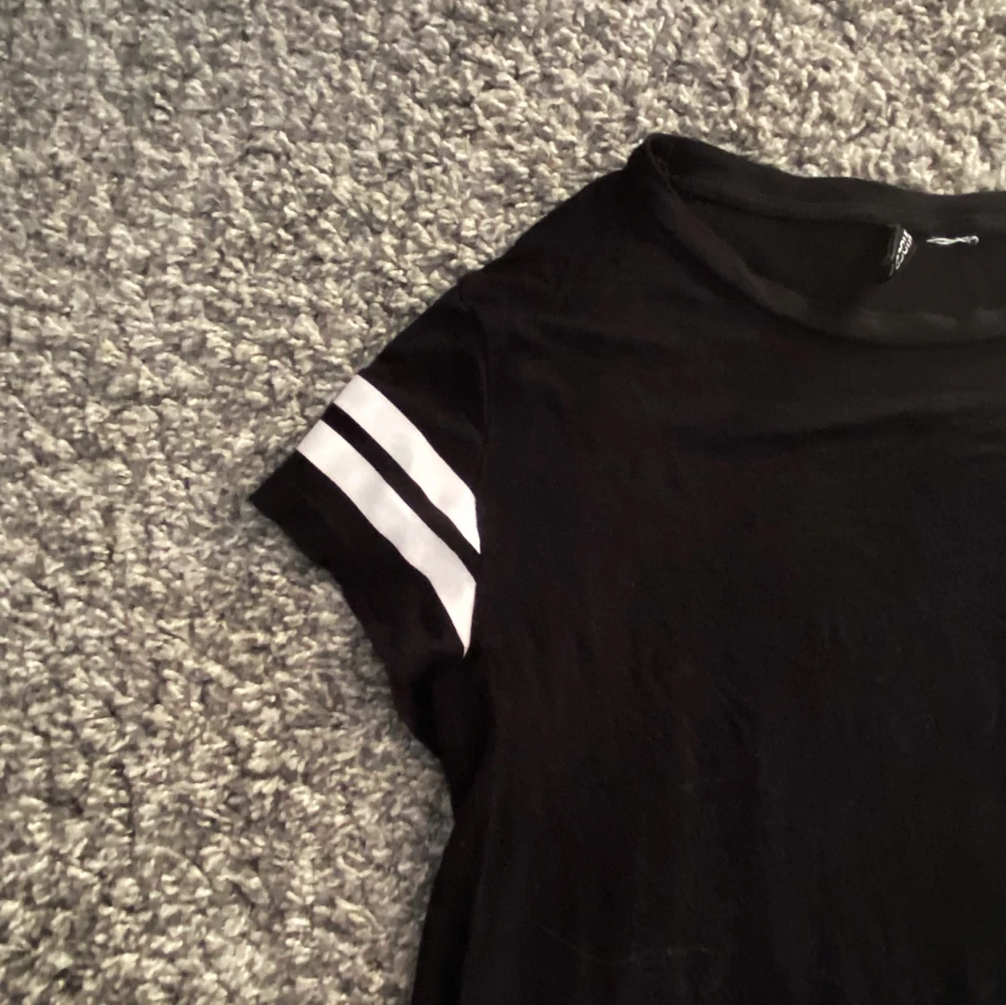 Svart topp med vita ränder på axlarna