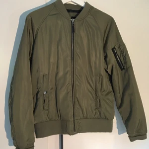  - En militärgrön bomber jacka från lager 157. Perfekt till hösten och vintern med tanke på att den är varm.  Säljer pga har för många jackor. Nypris = 400kr Säljes = 249kr  Kan budas.
