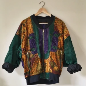  - Tunn bomberjacka med färger, mönster och detaljer / fickor med dragkedja / passar Strl S-L  Köparen står för frakt. 