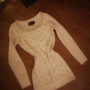 Knitwear Sweater. Size 8.  - Brand new. White with golden beads in front. Bought 1 year ago. Now is too tight for me. 100% acrylic. 