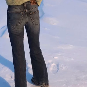 Lee Felton Flare Jeans - Ett par lee jeans i bootcut modell som jag köpte för ett tag sedan, tyvärr är de för små på mig annars hade jag gärna behållt dem själv✨ slitningar på ena benet men själv tycker jag det ger en cool effekt. På framsidan (vet inte om det syns)  har de en liten fläck(mindre än en ärtas storlek) men det är ej något man tänker på. Skriv privat för fler bilder💗 450kr+frakt (kan inte stå för postens slarv)  om fler är intresserade får ni buda🥰