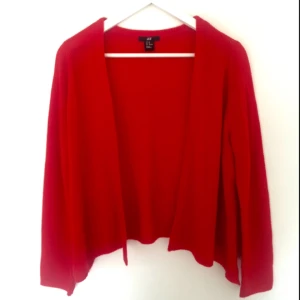  - Röd kofta från H&M. Sparsamt använd. Storlek XS, men fungerar även för större storlekar.