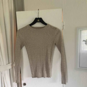  - Kabelstickad beige tröja från Gina. Säljer pga att den inte kommer till användning. Är storlek XS men skulle säga att den passar S också. 