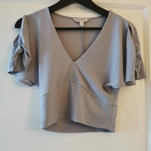 Topp  - Med detaljer vid armarna 