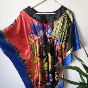 Beach dress - Colorful silky look like beach dress with a belt.