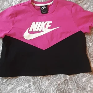 Nike cropped t-shirt - Cropped t-shirt, svart/rosa i bomull, använd tre gånger mycket bra skick