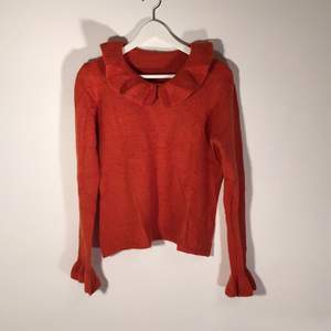 Knitted wool blouse in bright orange